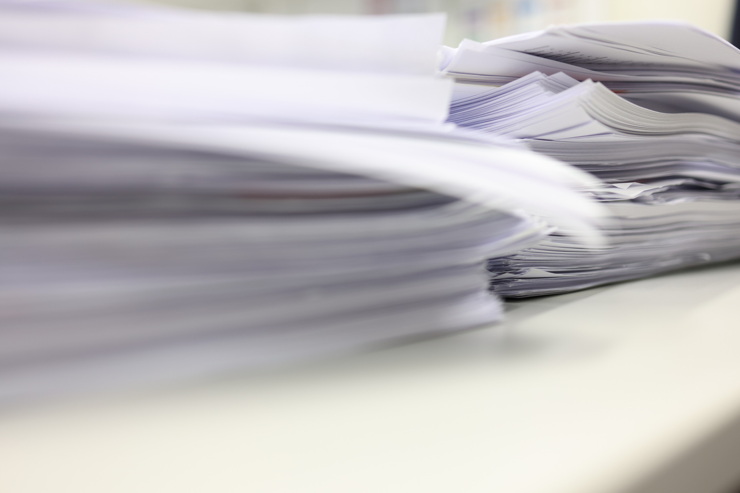 Pile of documents on the desk in the office, business concept